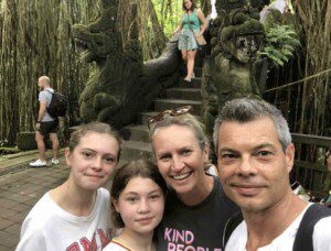 Image of Lucy, Alice Nicole and Dru in front of an temple entrance in Bali