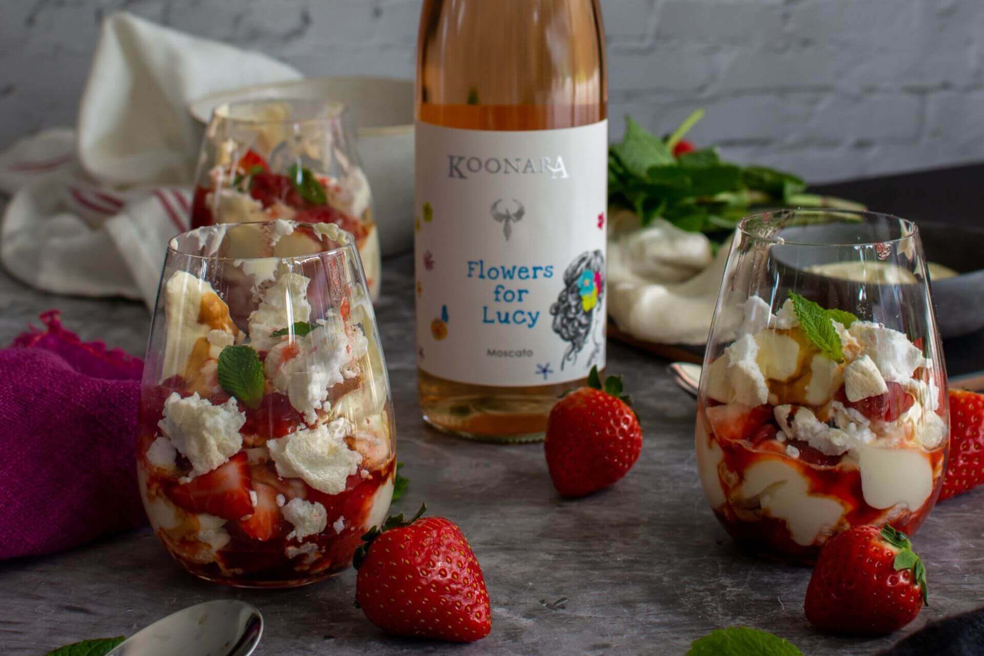 A bottle of Flowers for Lucy Moscato with 2 glasses of Eton Mess