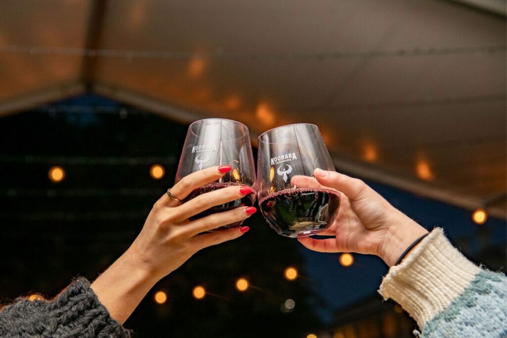 Cheers to global drink wine day - Two people clinking their Koonara Wines glasses of Red Wine together